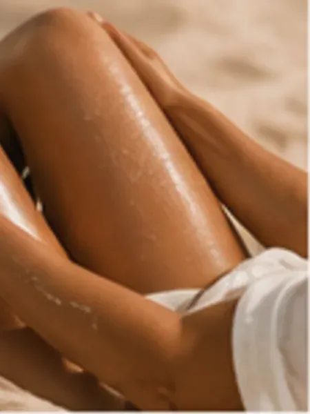 Evenly tanned legs resting on warm sand