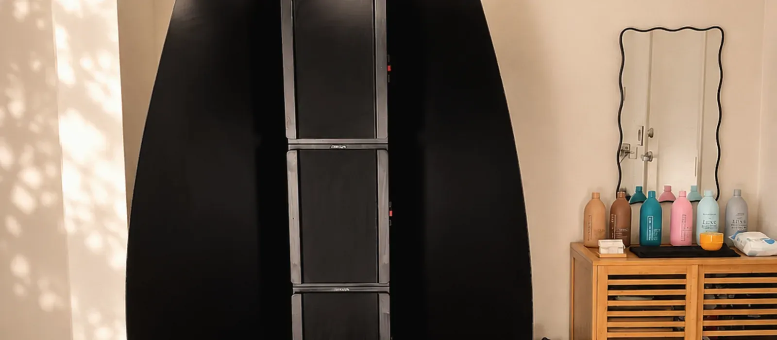 The spray tan booth and extraction setup in the Secret Tanning Co studio